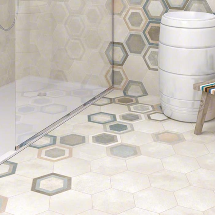 Bathroom with multicoloured hexagon tiles and a glass shower