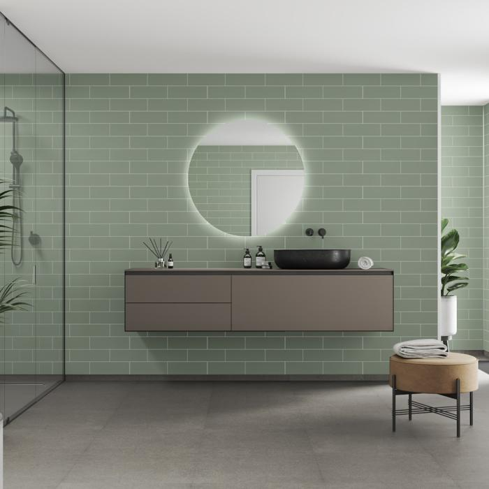 Pale green tiled walls in a bathroom with a floating vanity