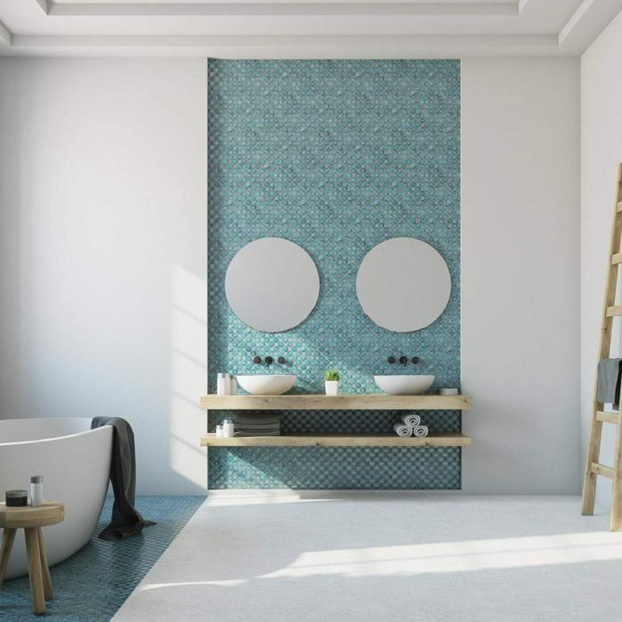 Bathroom with blue patterned wall panels and a freestanding tub