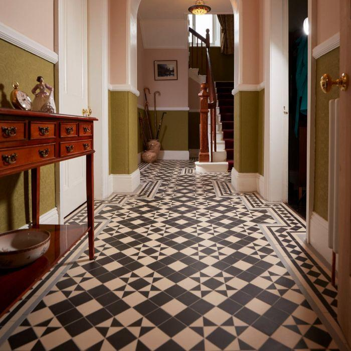 Black and white diamond-patterned tiles in elegant entryway