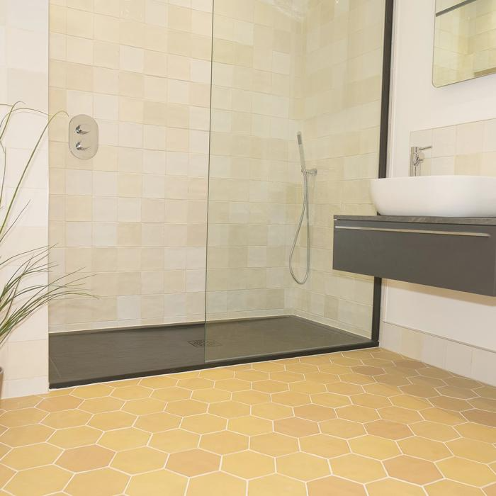 Modern bathroom with yellow hexagon floor tiles and beige walls