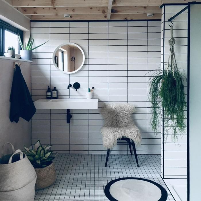 White grid-pattern tiles in a bathroom with wooden ceiling