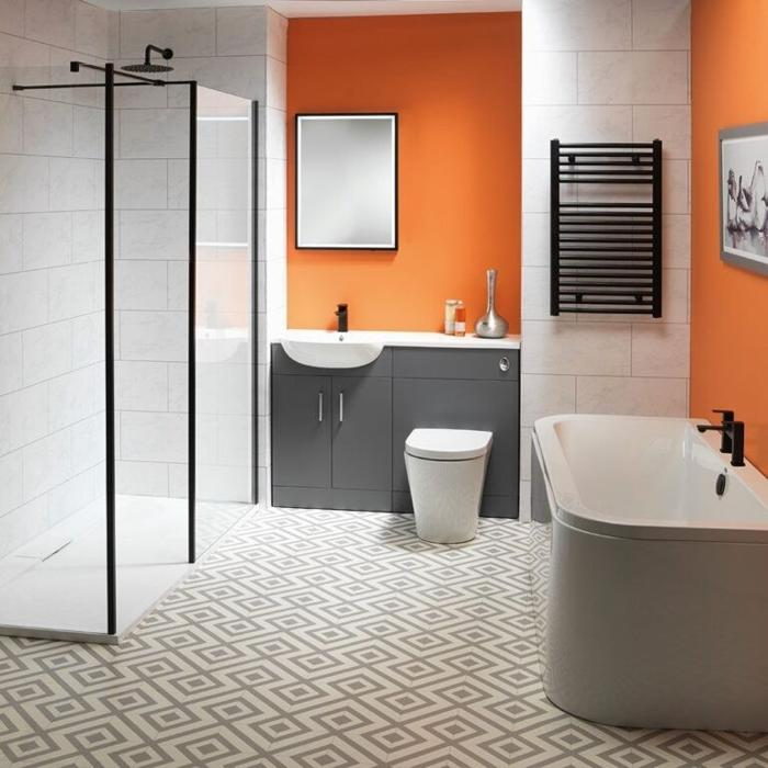 Bright orange feature wall with grey and white bathroom fixtures