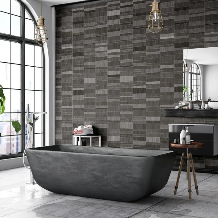 Spacious bathroom with dark textured tiles and a black freestanding tub