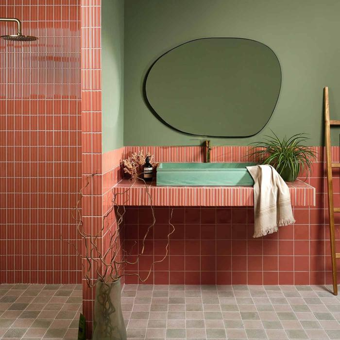 Green and terracotta bathroom with geometric wall tiles