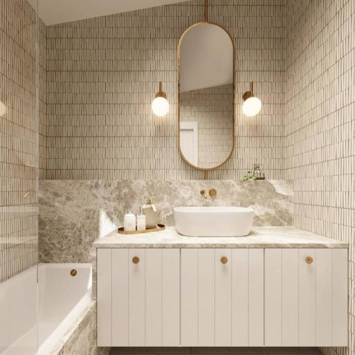 Elegant beige bathroom with vertical tile patterns and a marble countertop