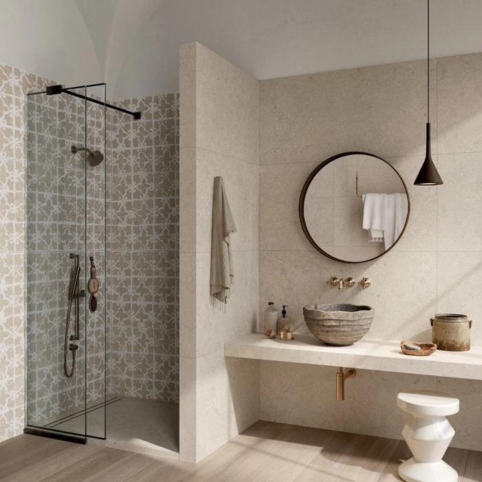 Neutral-toned bathroom with patterned shower tiles and minimalist decor