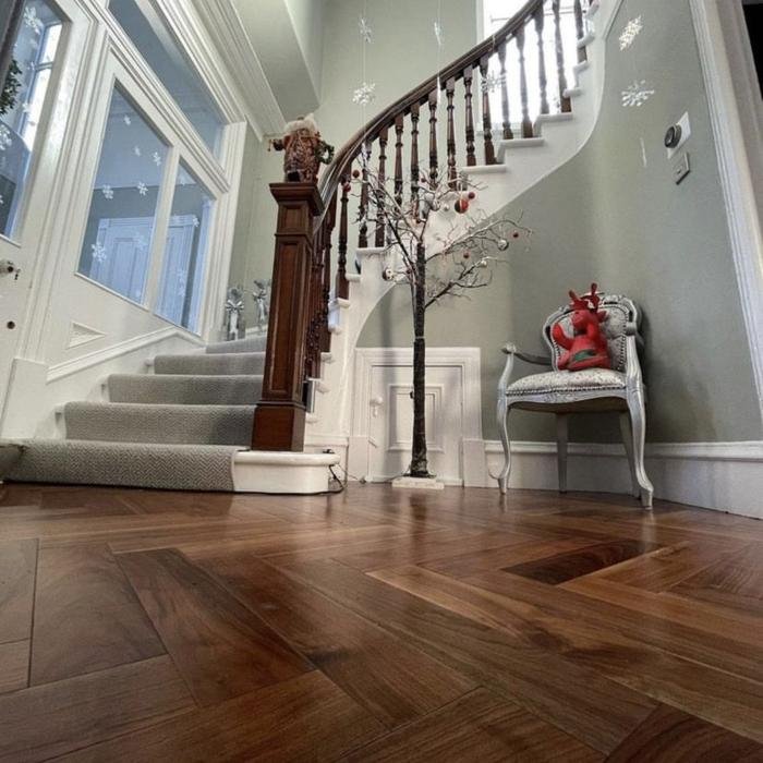 Traditional hallway with dark parquet flooring