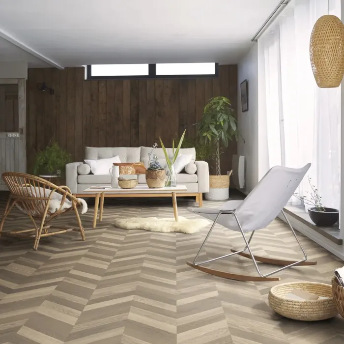 Modern living room with chevron patterned oak flooring