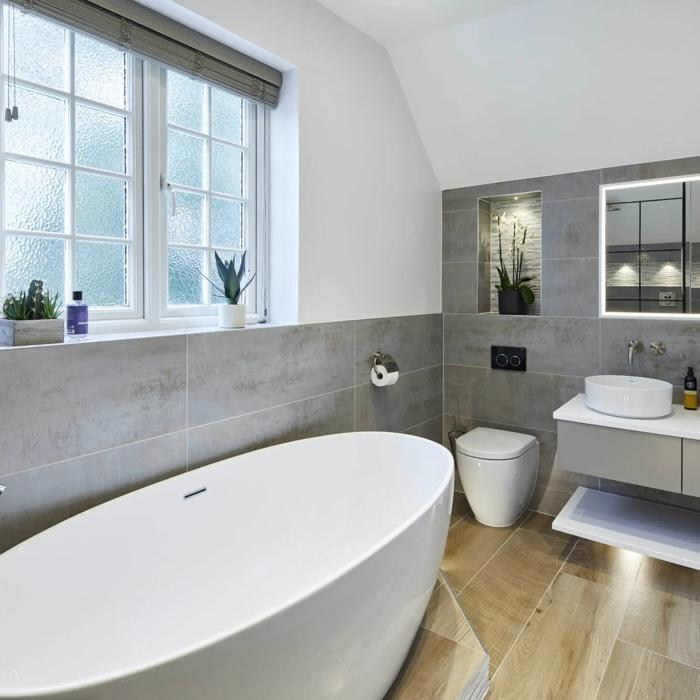 Modern bathroom with grey tiles and wooden flooring