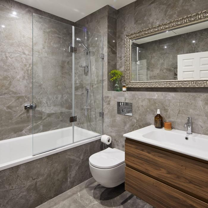 Bathroom with marble effect tiles and wood vanity