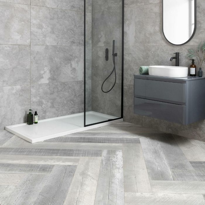 Mixed grey wood effect tiles in a spacious bathroom