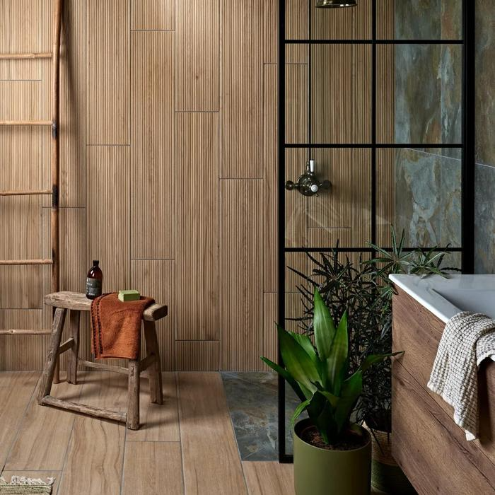 Bathroom with wood-textured walls and green plants