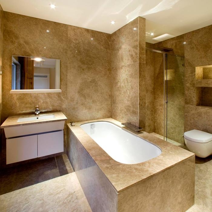 Luxurious bathroom with marble tiles and freestanding bathtub