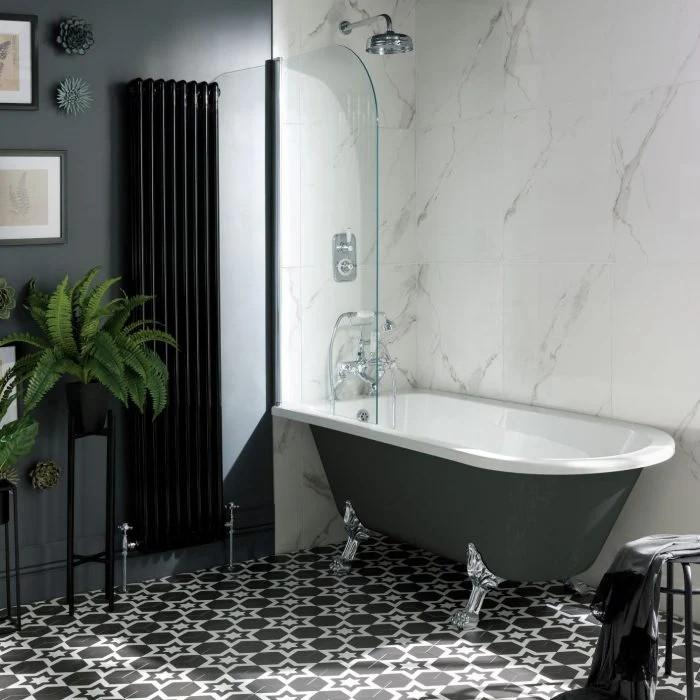 Clawfoot tub with marble wall and black and white floor tiles