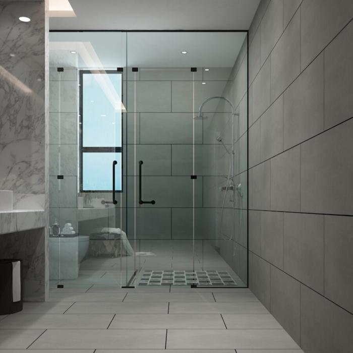 Modern bathroom with concrete effect tiles and glass shower