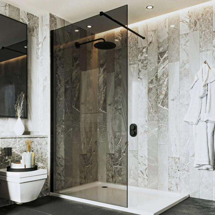 Dark glass shower screen with marble wall tiles