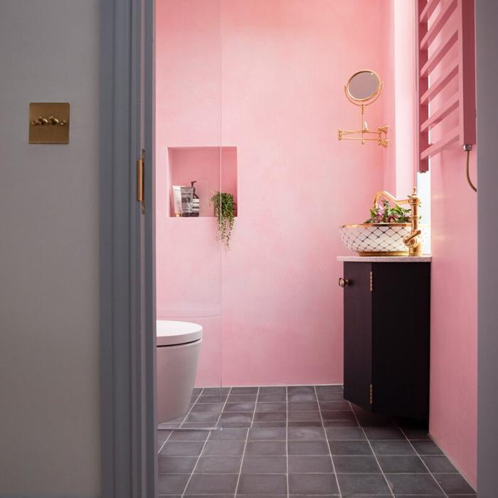 Small bathroom with pink walls and grey floor tiles