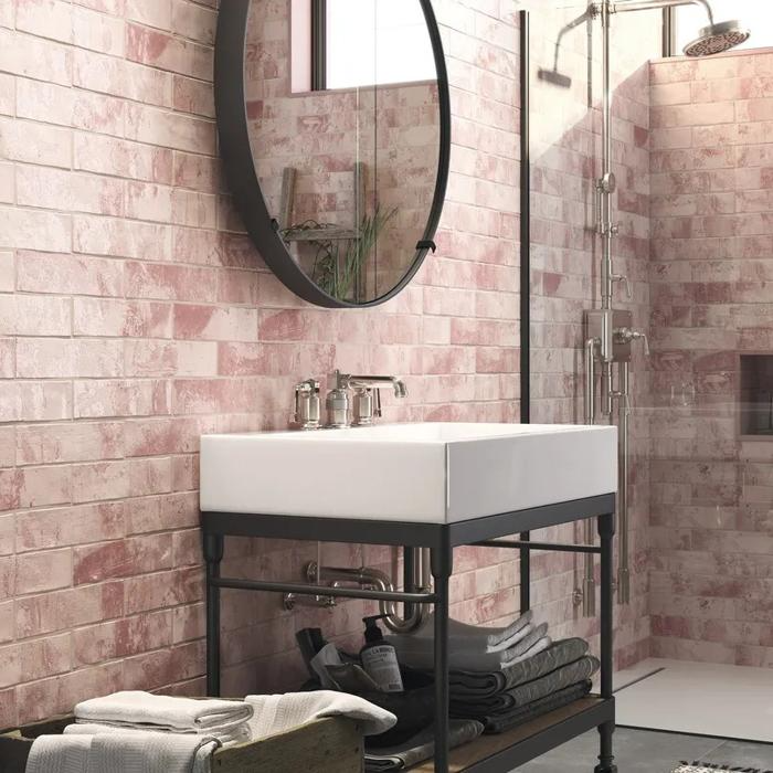 Rustic bathroom with pink textured wall tiles