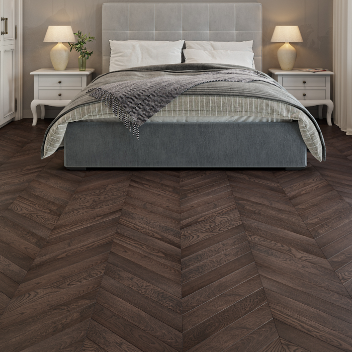 Cosy bedroom with dark chevron wooden flooring