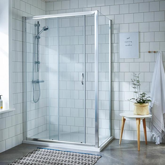 White-tiled walk-in shower with glass enclosure