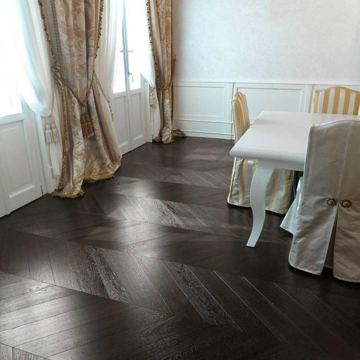 Luxurious dining room with black polished chevron flooring