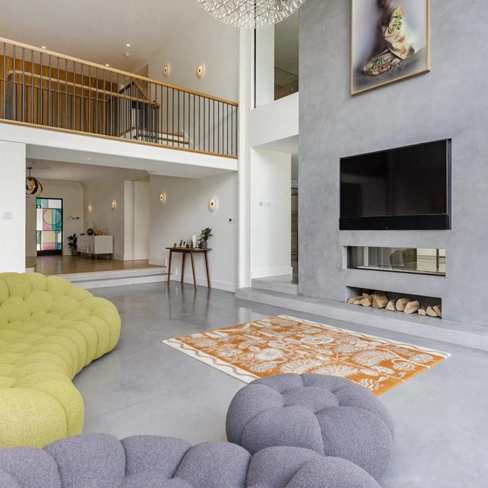 Modern living room with polished concrete floor and colourful sofas