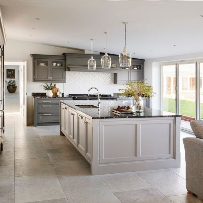 Spacious kitchen with large natural stone tiles