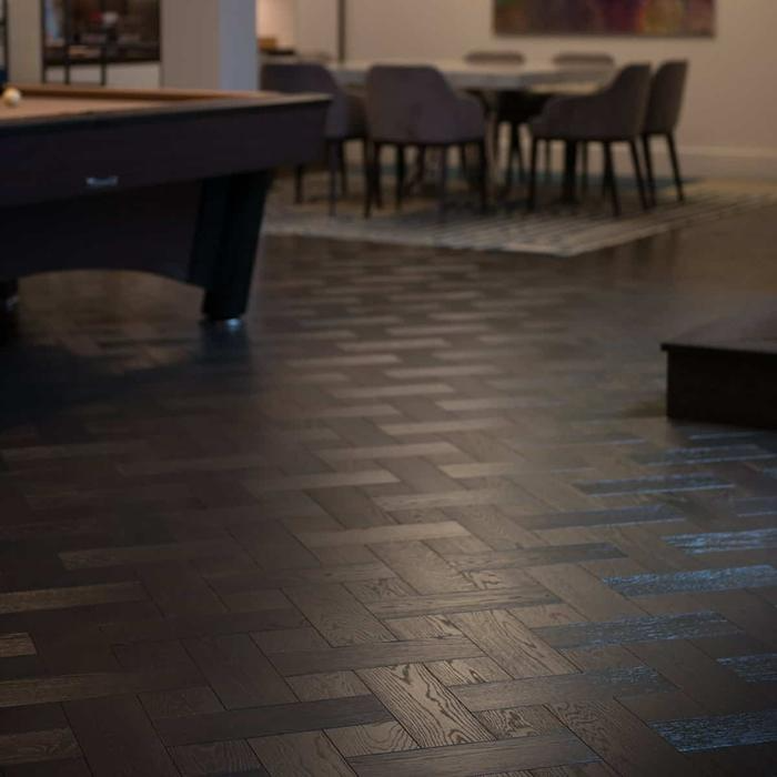 Dark parquet flooring in game room