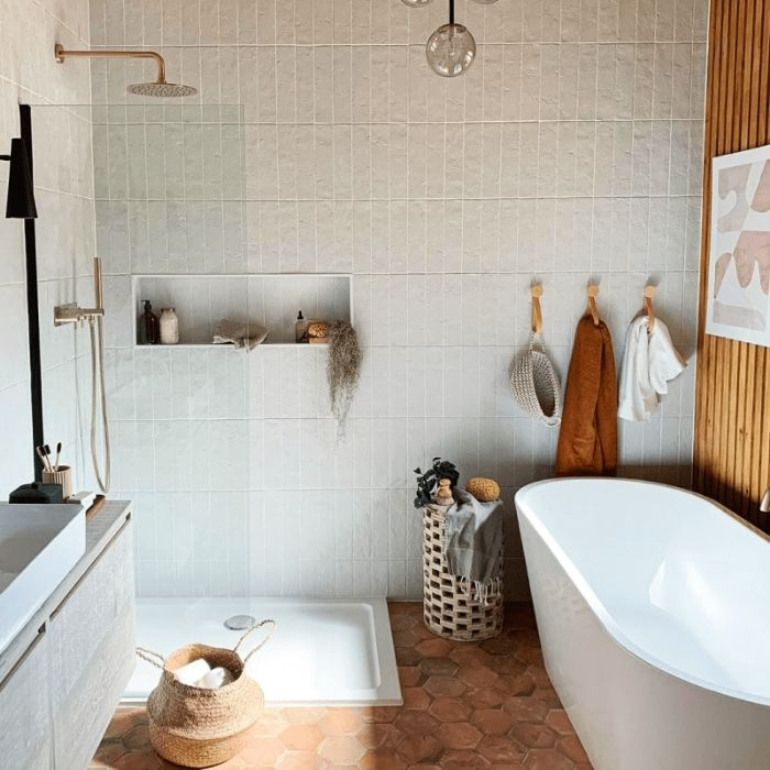 White rectangular tiles and warm wood accents in bathroom