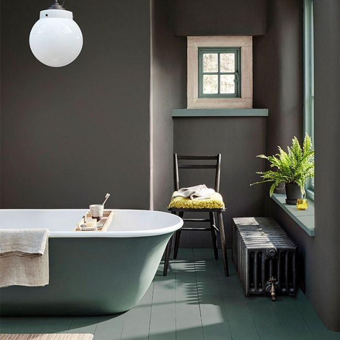 Grey painted walls with wooden vanity and white bathtub