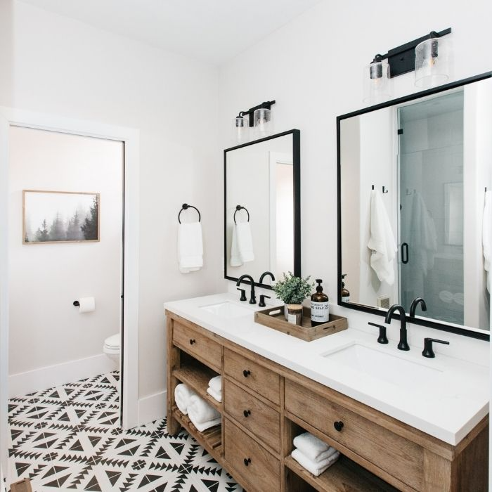 Bathroom with patterned floor tiles and a wooden double vanity