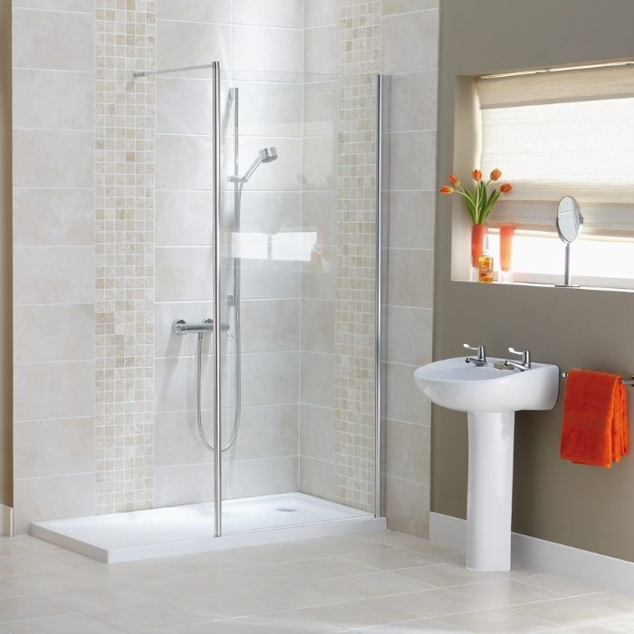 Light beige tiles with a raised shower tray and mosaic accents