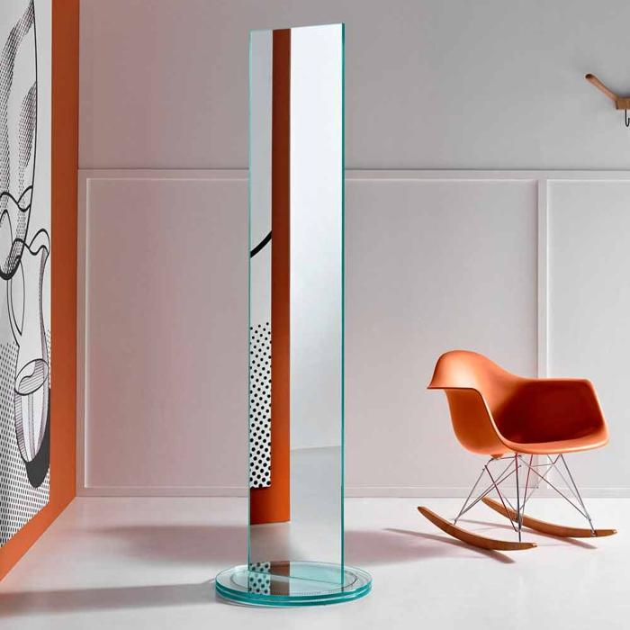 Tall thin double-sided mirror with orange chair in modern room