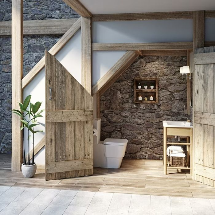 Rustic bathroom with exposed stone walls and wooden door