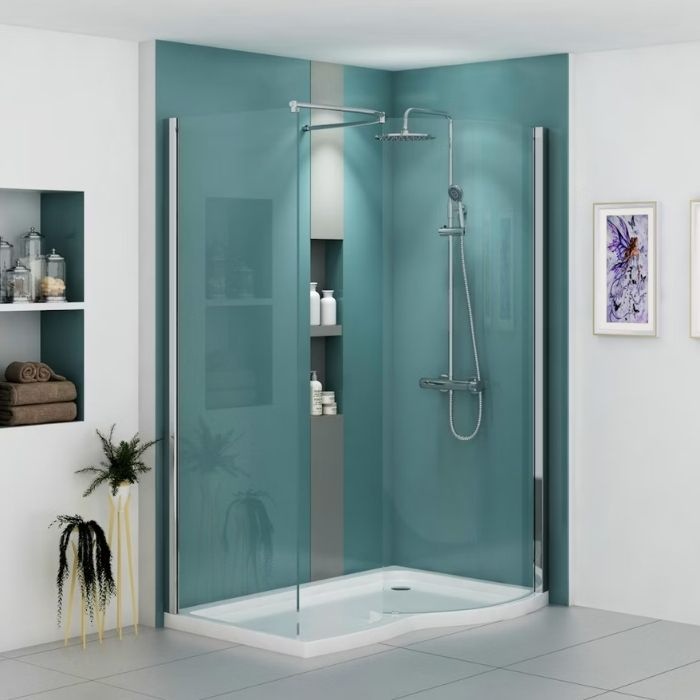 Teal glass shower walls with a curved raised shower tray