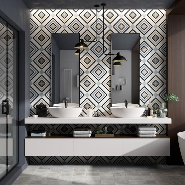 Geometric pattern tiles behind double sinks in a bathroom