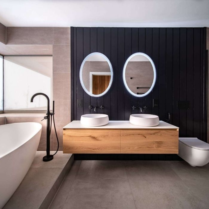 Dark wood panelling with modern fixtures in a family bathroom