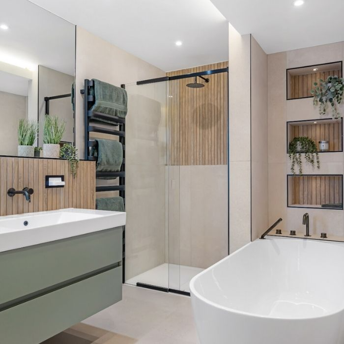 Neutral tiles with green accents in a modern family bathroom