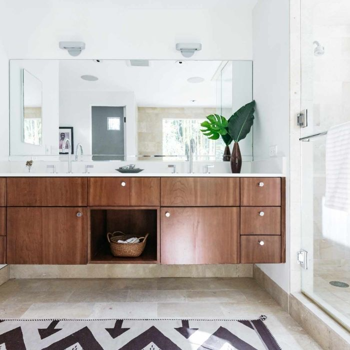 Contemporary bathroom with wood vanity and large mirror