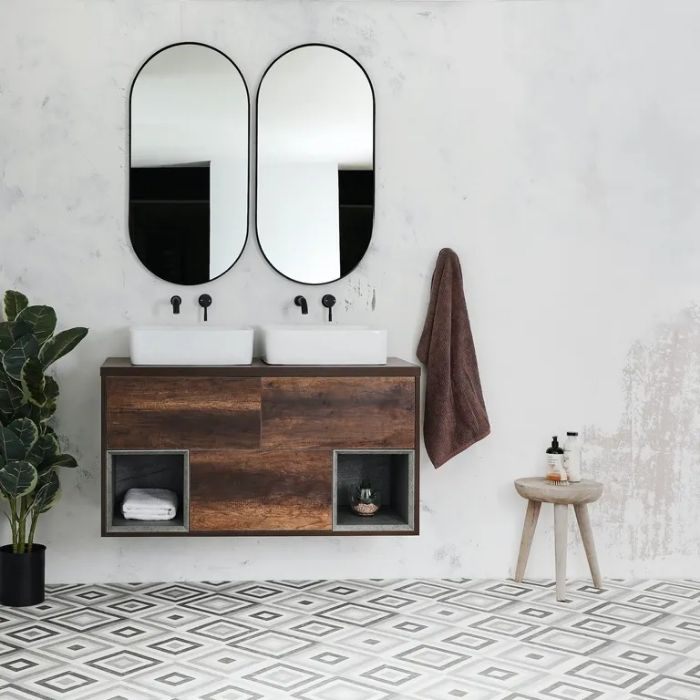 Bathroom with patterned floor tiles and double mirrors