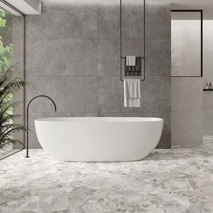 Minimalist bathroom with stone tiles and freestanding tub