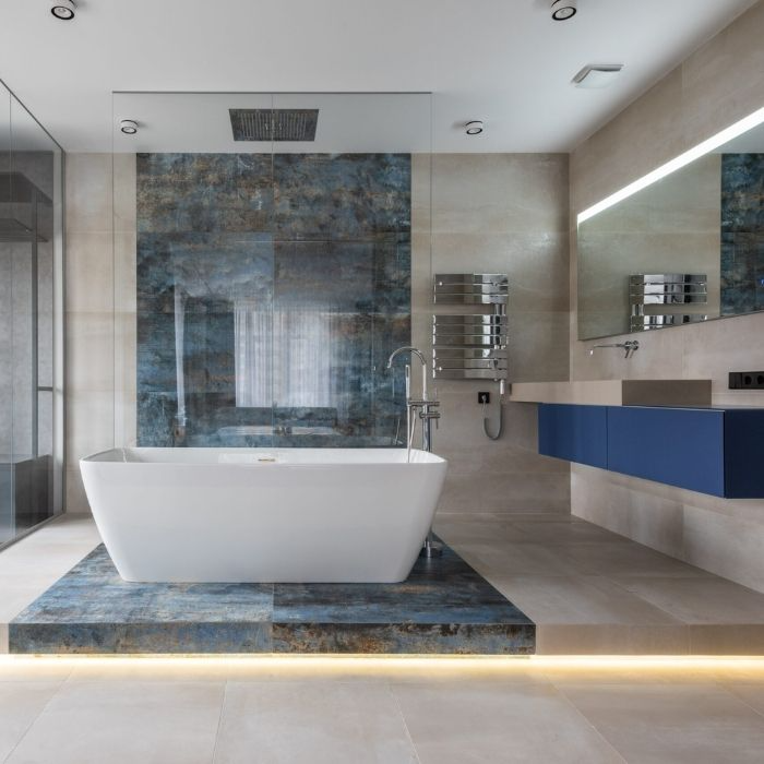 White freestanding bath with blue accent tiles in modern bathroom