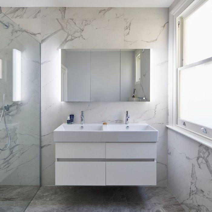 White marble tiles with double vanity in a bright bathroom