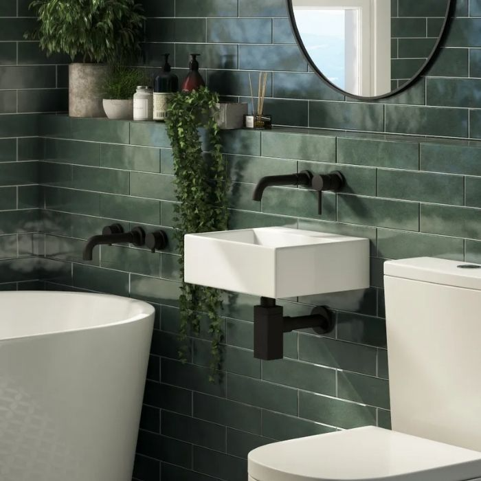 Glossy green subway tiles with black fixtures