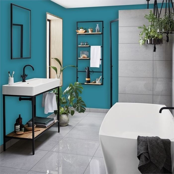 Bright blue painted walls with large grey floor tiles