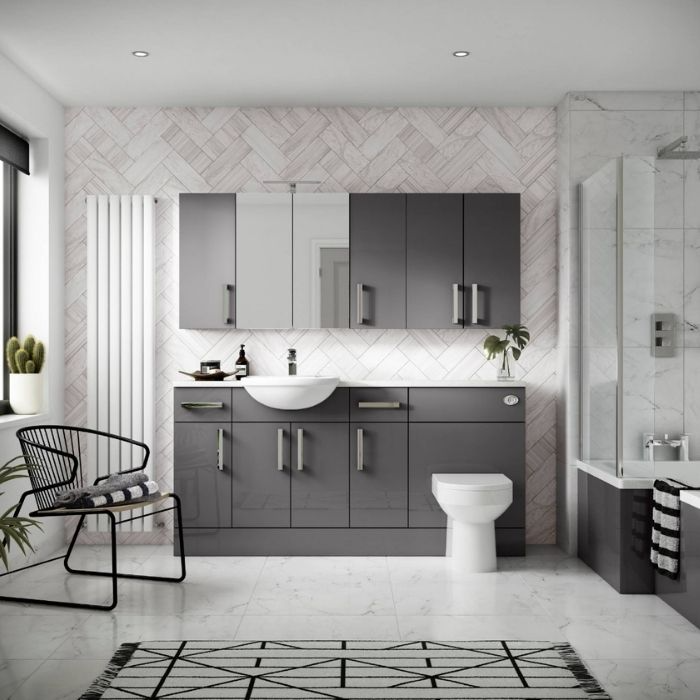 Grey vanity with herringbone wall tiles and marble floor