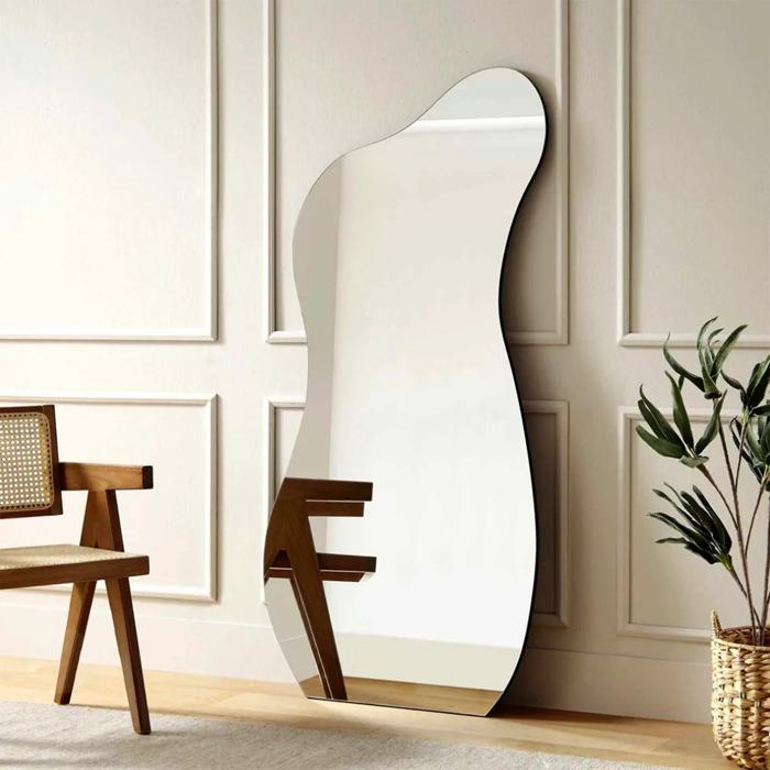 Wavy mirror on the floor with chair