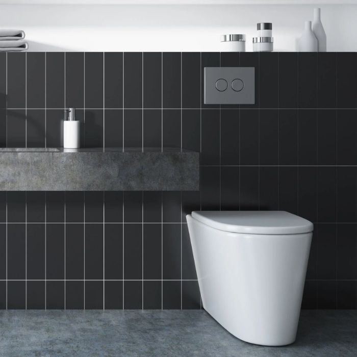 Modern bathroom with black vertical tiles behind a floating sink