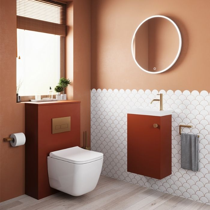 Terracotta tones with white scallop tiles in stylish bathroom